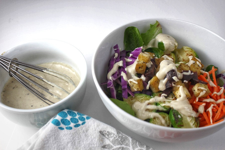 Beachbody Meal Plan Close Up of a Buddha Bowl with a Bowl of Dressing Next to it