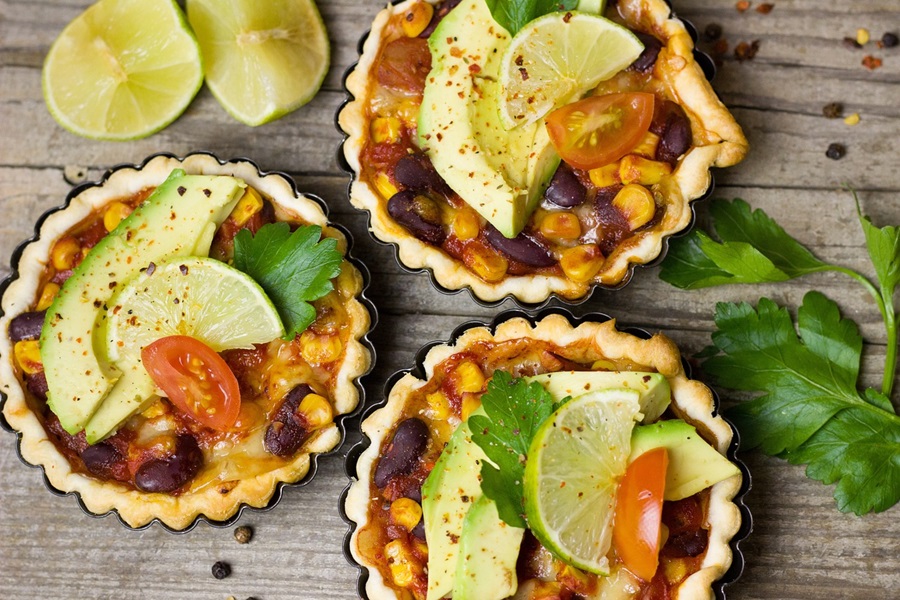 Best of Cinco de Mayo Recipes for Close Up of Tortilla Soup Topped with Avocado Slices and Lime Wedges
