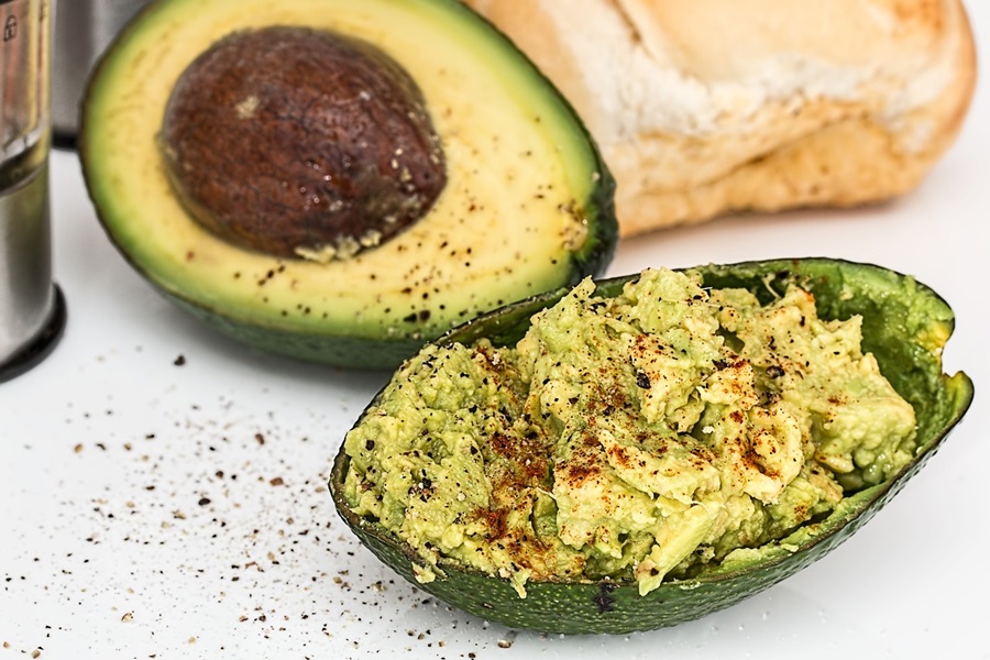 Cinco de Mayo Foods for Fiestas an Avocado Cut in Half with Half of it Mashed Up in the Skin