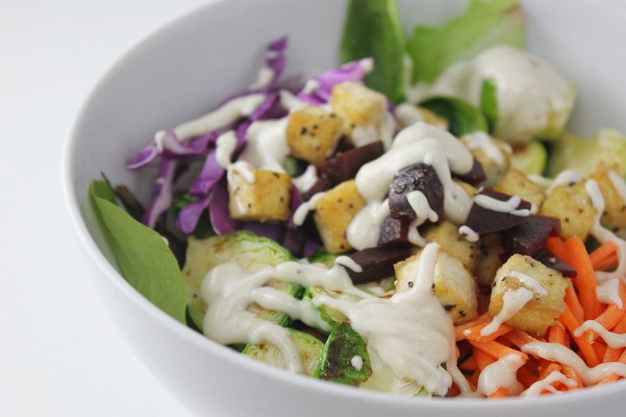 2B Mindset Meal Plan Ideas for Lunch Close Up of a Buddha Bowl with a Dairy Free Sauce Drizzled On Top