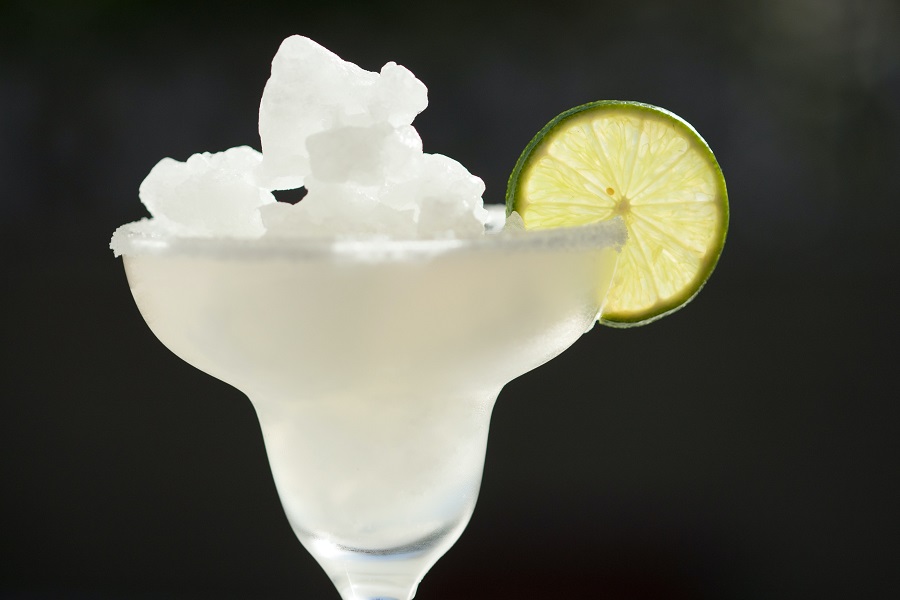 Margarita Pitcher Recipes that are Perfect for Parties Close Up of a Slushie Margarita with a Lime Slice on the Rim of the Glass