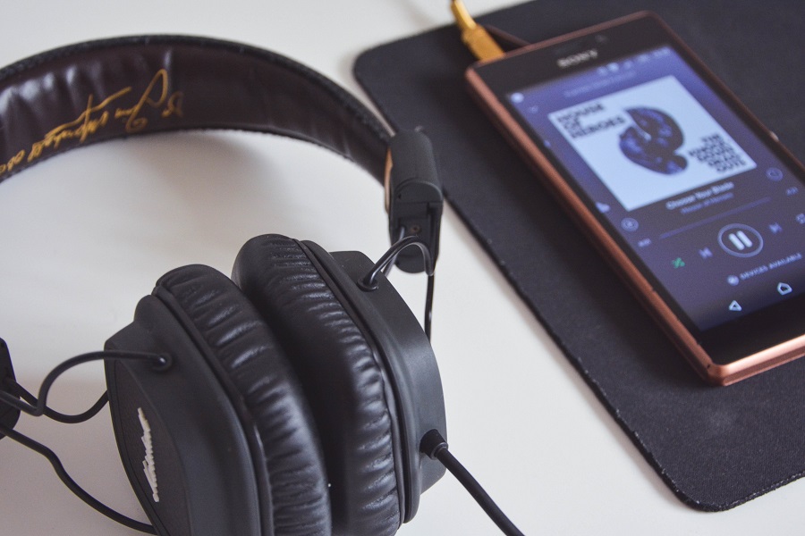 Amazon Echo Show Close Up of Headphones Next to a Device Playing Music