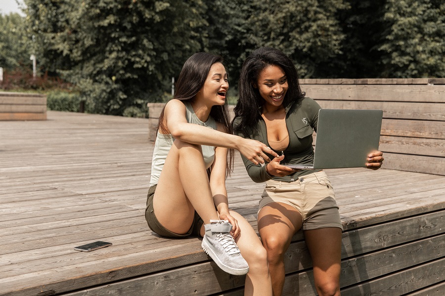 Amazon Echo Show Two Young Girls Looking at a Laptop Laughing