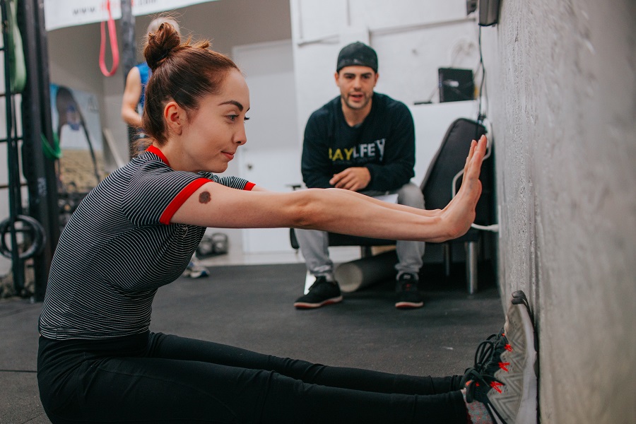 Amazon Echo Show a Woman Working Out in a Gym with a Personal Trainer