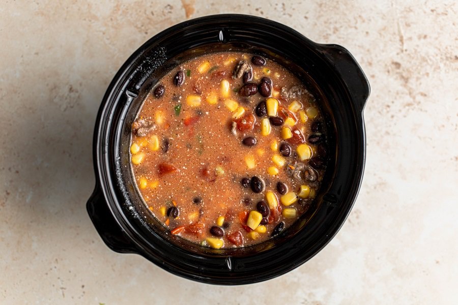 Crockpot Taco Soup Recipe Overhead View of a Crockpot Filled with Ingredients for Taco Soup