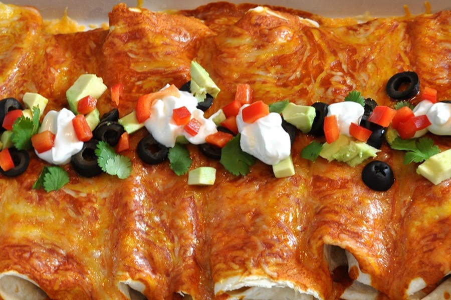 Easy Chicken Enchiladas Recipe Enchiladas in a Row Inside a Baking Dish