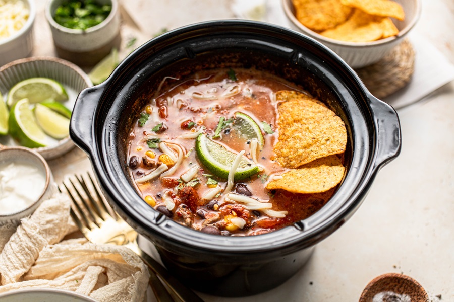 Easy Crockpot Taco Soup Recipe a Crockpot Insert Filled with Soup and Topped with Chips and a Lime Wedge