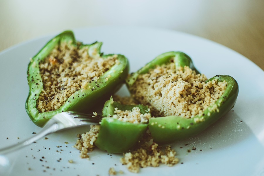 What Can You Eat on a Pegan Diet Close Up of a Bell Pepper Cut in Half Filled with Grains