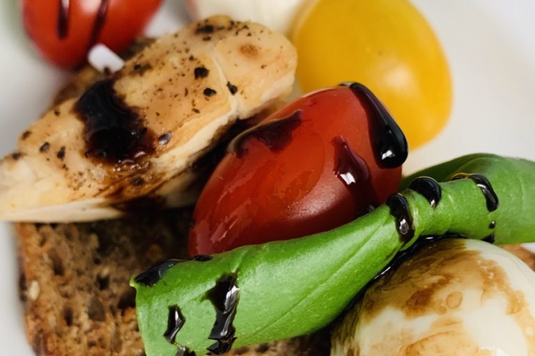 Easy Caprese Flatbread Recipe Close Up of the Chicken, Tomatoes, Basil, and Cheese on a Skewer with Balsamic Vinaigrette