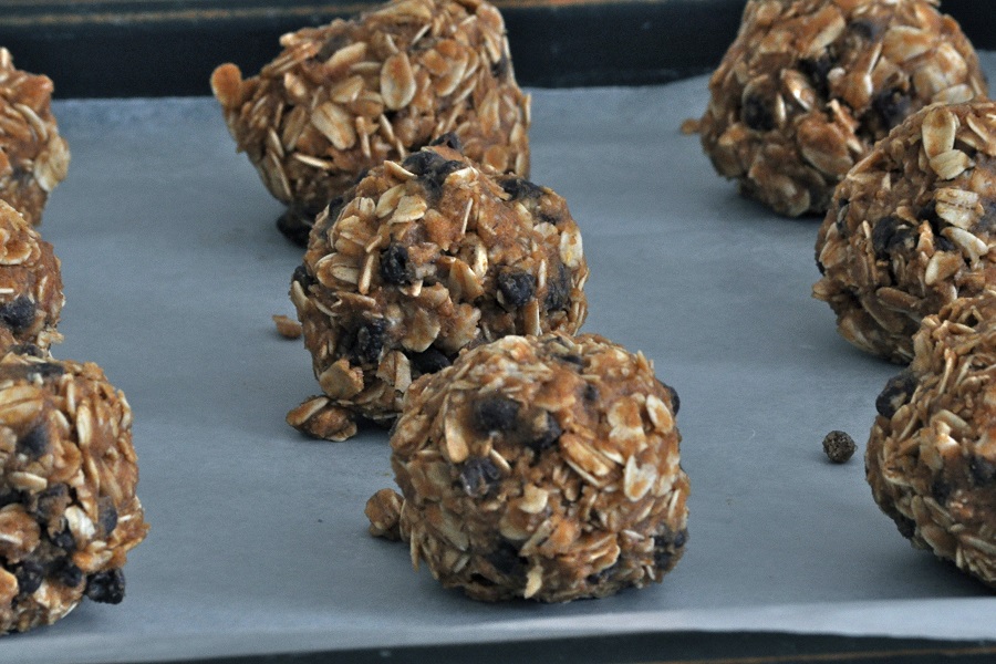 Peanut Butter Oatmeal Balls Close Up of Peanut Butter Balls on Parchment Paper in Rows