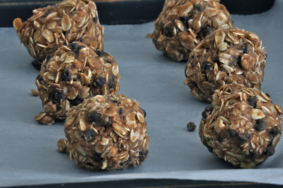 Peanut Butter Oatmeal Balls on Parchment Paper on a Baking Sheet to Dry