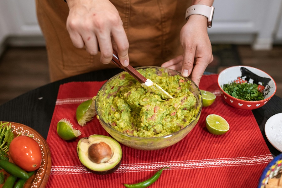 Crockpot Chicken Burrito Bowl Recipes a Woman Mixing Guacamole with Fresh Avocados