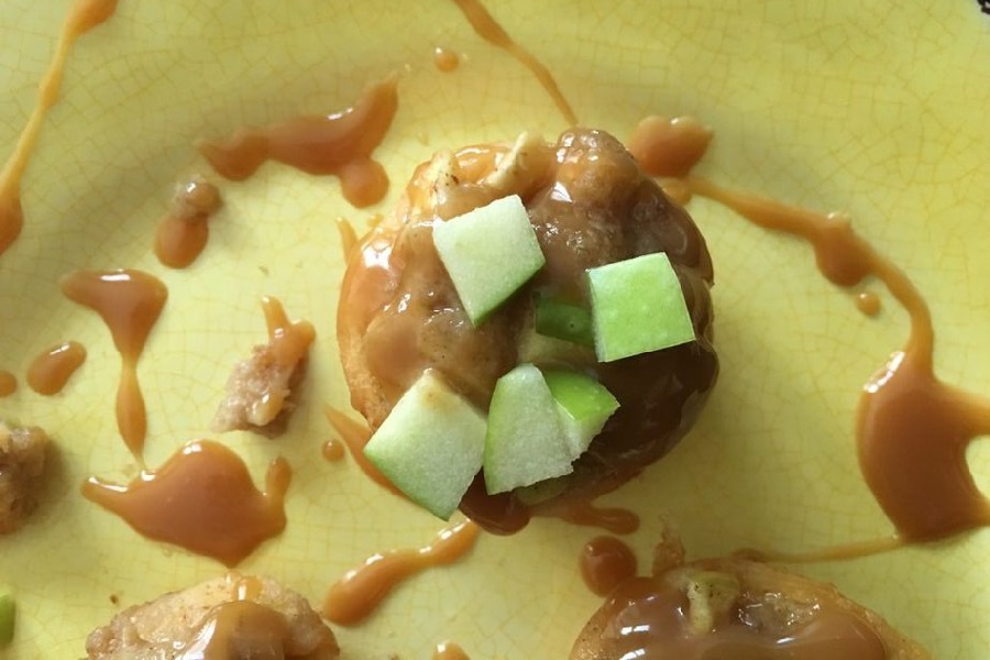 Fall Recipes Close Up of an Apple Crumble Cup Covered in Caramel and Topped with Apple Chunks