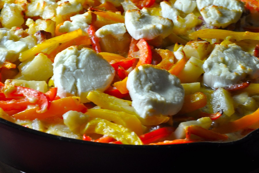 Breakfast Frittata Recipe with Potatoes Close Up of Fritata in a Skillet Topped with Goat Cheese and Bell Peppers