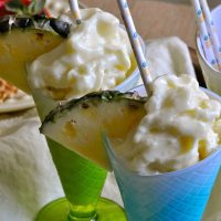 Make at Home Dole Whip Recipe Two Glasses of Dole Whip Each Garnished with a Straw and a Pineapple Wedge
