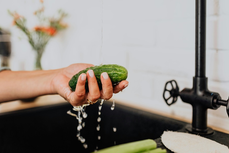 Master Your Metabolism Reviews and What's to Love Close Up of a Pickle Being Washed in a Sink