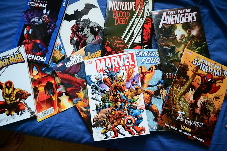 Marvel Movies in Order A Stack of Comic Books Spilled on a Bed