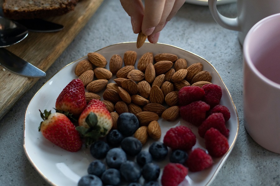 Diabetic Snacks Store Bought a Small White Plate Filled with Almonds and Assorted Berries