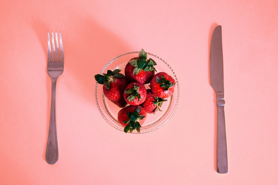 Diabetic Snacks Store Bought a Small Bowl of Strawberries on a Pink Surface