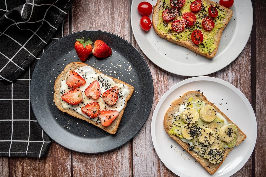 Diabetic Snacks Store Bought Three Pieces of Toast on Separate Plates Each Topped with Different Types of Fruit