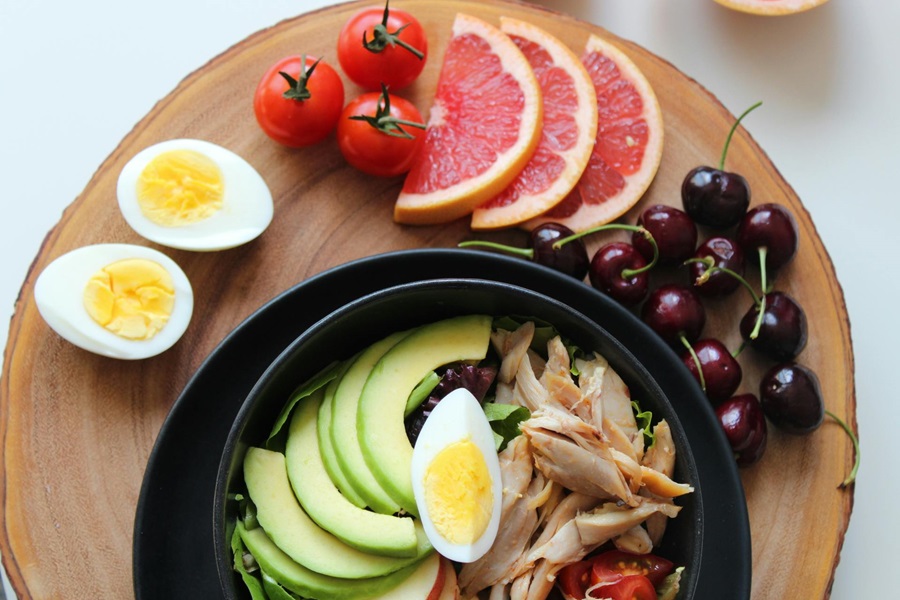 Are Keto Recipes Good for Diabetics Close Up of a Chicken Bowl with Avocado, Hard Boiled Eggs, and Fruit Slices