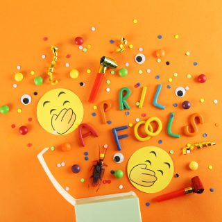 April Fools Day Pranks to Play on Your Husband Colorful Plastic Letters on an Orange Surface That Spell Out April Fools with Laughing Emojis and Confetti