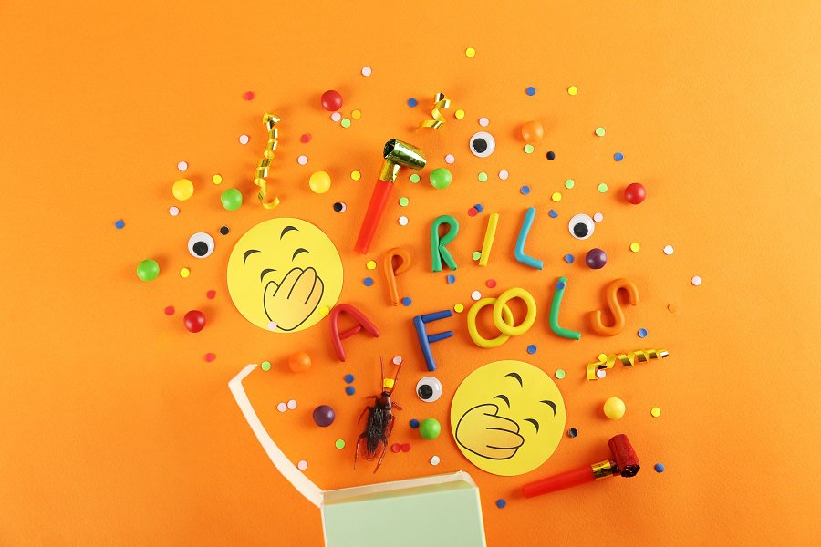 April Fools Day Pranks to Play on Your Husband Colorful Plastic Letters on an Orange Surface That Spell Out April Fools with Laughing Emojis and Confetti