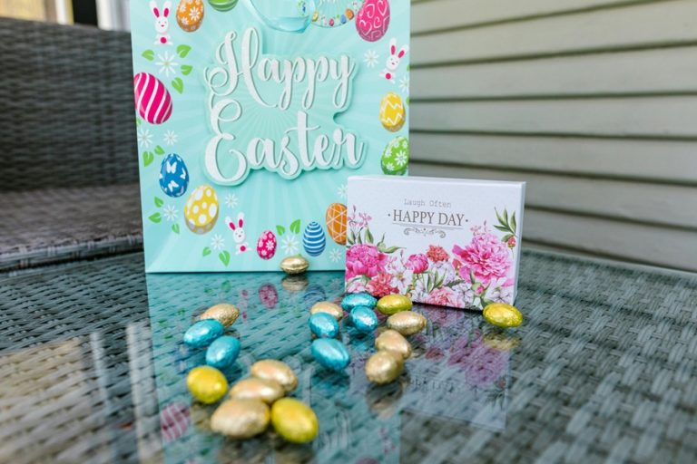 Easter Appetizers a Happy Easter Card on a Glass Table with Candy Eggs Outside