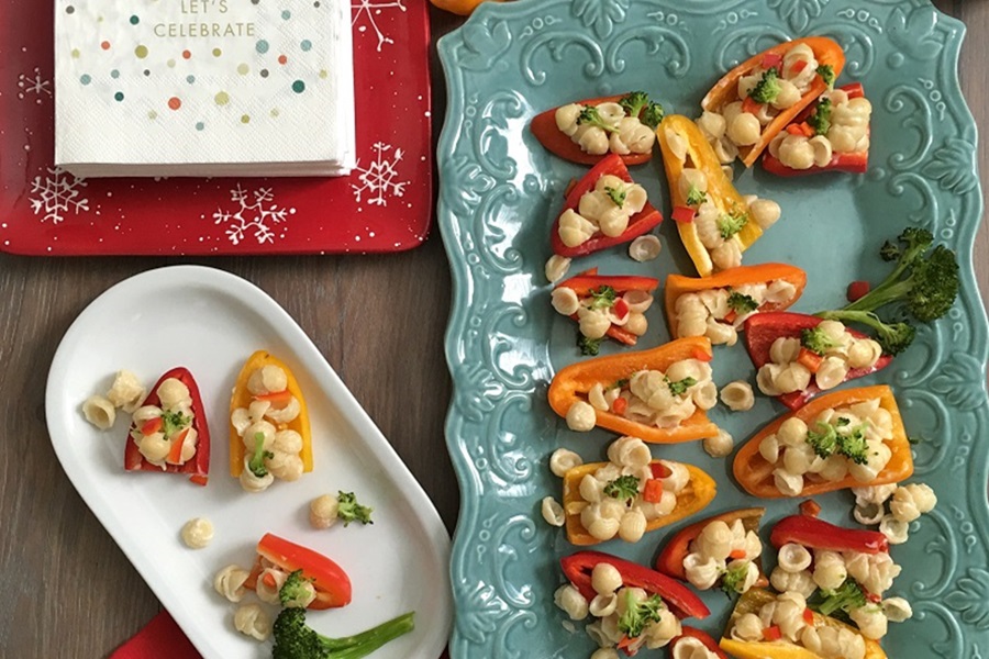 Easter Appetizers A Serving Platter Filled with Mini Bell Pepper Mac and Cheese Bites Next to a Small White Plate of the Same