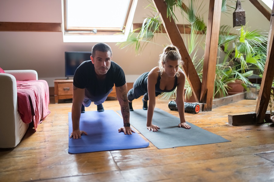 Morning Meltdown 100 Tips and Tricks a Couple Doing Planks in a Room with Plants and a Window