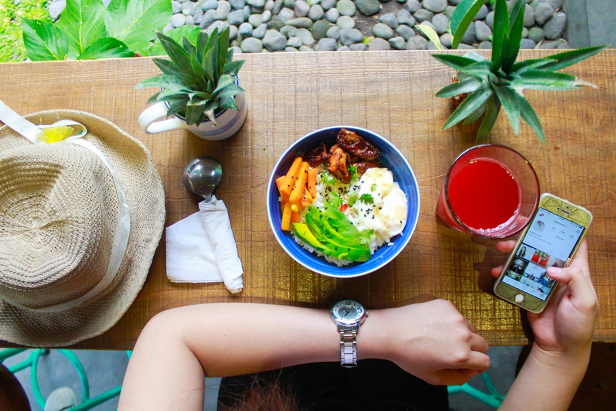 Whole30 vs Paleo vs Keto a Person's Arm Resting on a Table with a Bowl of Food in Front of the Arm