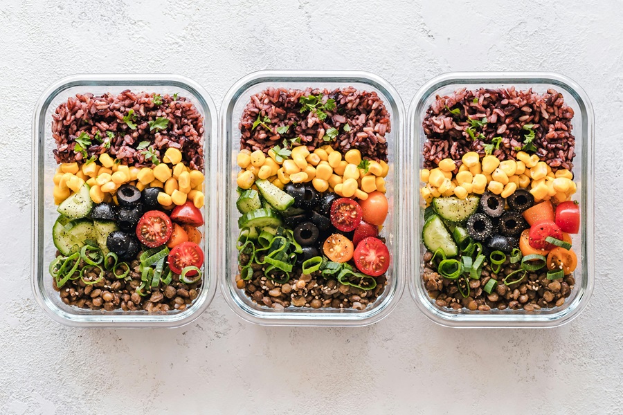 Whole30 vs Paleo vs Keto Overhead View of Three Meal Prep Containers Filled with Food