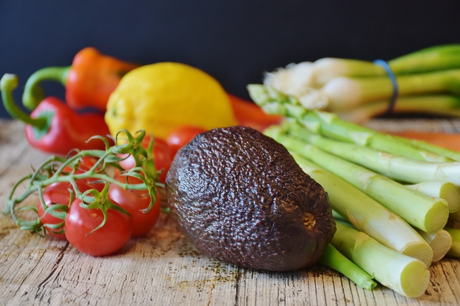 Tips for a Low Carb Diet Close Up of Veggies Including Asparagus, Avocados, And Tomatoes with Lemon