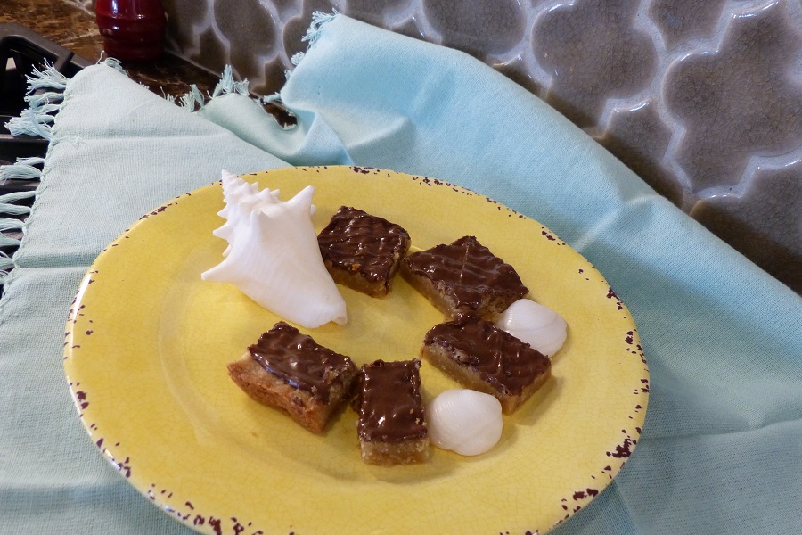 Super Soft Toffee Bars Recipe Yellow Plate on a Blue Cloth Napkin and Toffee Bars