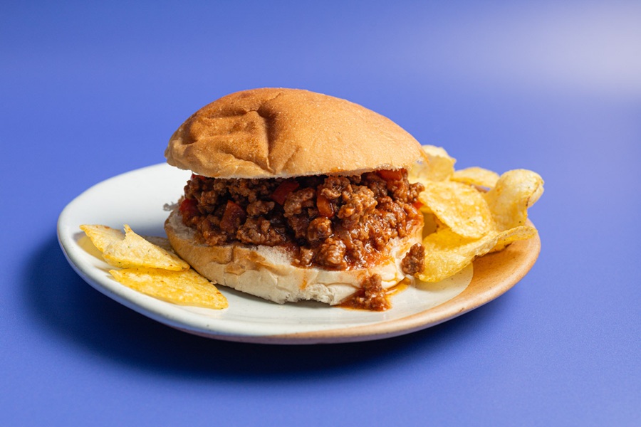 Easy Slow Cooker Sloppy Joes Recipe a Sloppy Joe on a Plate with Potato Chips