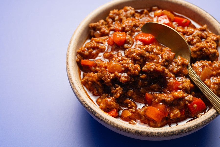 Easy Slow Cooker Sloppy Joes Recipe a Bowl of Sloppy Joe Meat Mixture with a Metal Spoon Inside