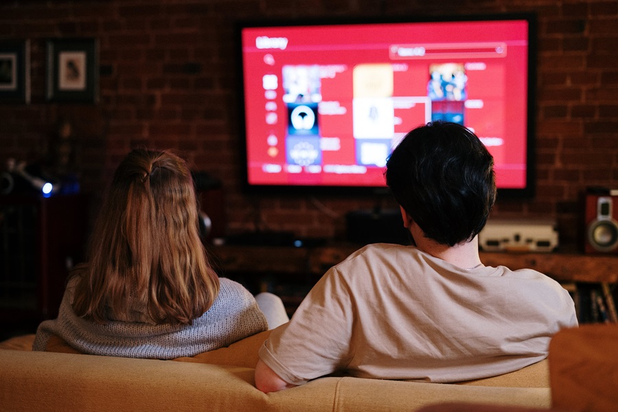 Amazon Fire TV Tips and Tricks a Couple Sitting on a Couch Watching TV