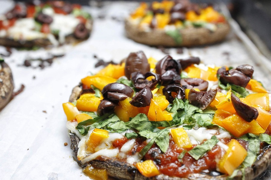 Easy Healthy Mushroom Pizza Recipe Close Up of a Baking Sheet with Portobello Mushroom Pizzas with Different Toppings