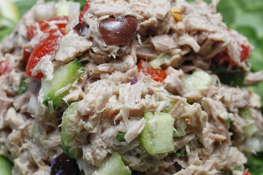 Low Carb Tuna Salad Close Up of a Mound of Tuna Salad with Celery, Olives, and Tomatoes