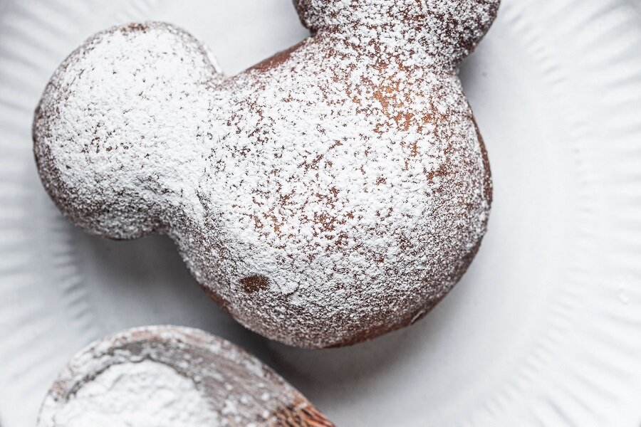 Copycat Disneyland Beignets Recipe Close Up of a beignet Covered with Powder Sugar