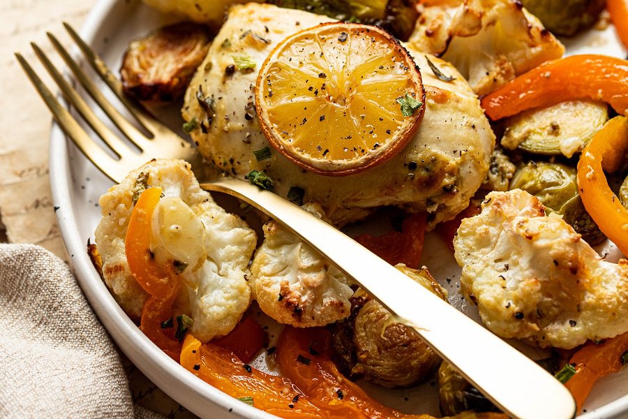 Low Carb Chicken and Veggies Sheet Pan Dinner Recipe Close Up of a Plate of Chicken with Roasted Veggies and a Fork