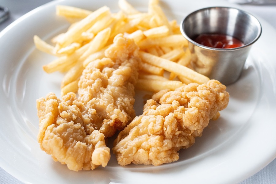 21 Tasty Ketogenic Chicken Strips Recipes Close Up of a Plate of Chicken Strips with Fries and Ketchup