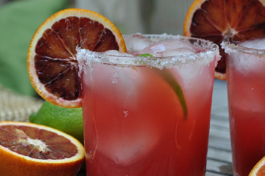 Best Winter Margarita Recipes for a Crowd Close Up of a Blood Orange Margarita with a Blood Orange Slice on the Rim