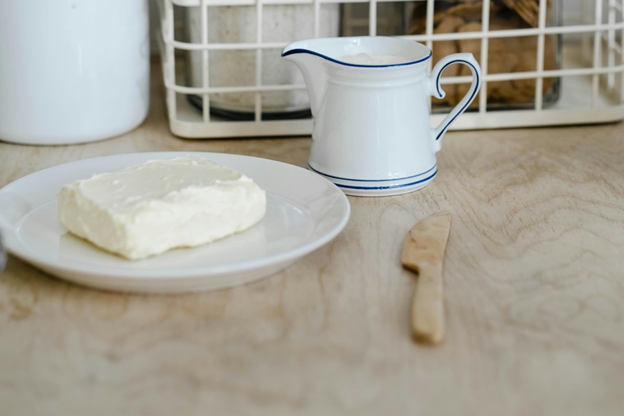 Low Carb Desserts with Cream Cheese a Plate of Cream Cheese with a Butter Knife and a Small Milk Pitcher Next to it