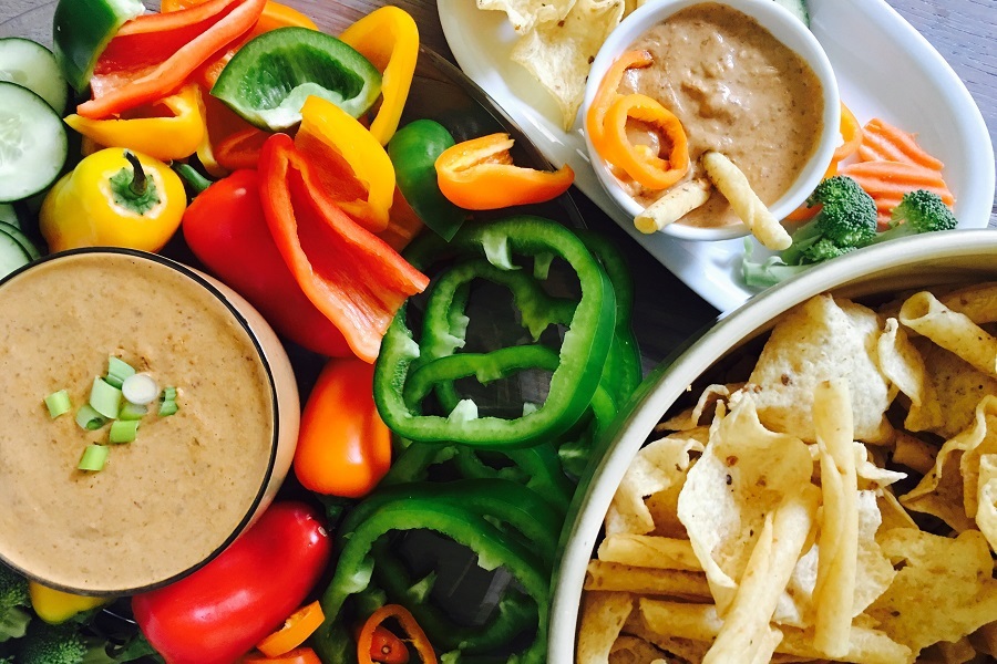 Super Bowl Appetizers Overhead View of a Plater of Sliced Bell Peppers and Black Bean Dips 