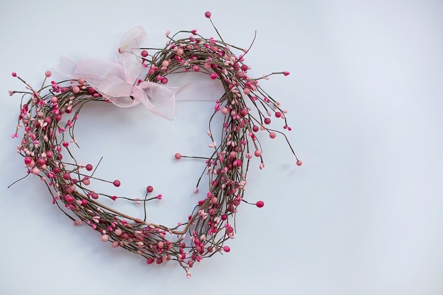 Valentines Day Desserts Ideas Close Up of Heart Made of Sticks and Flowers with a Pink Ribbon at the Top