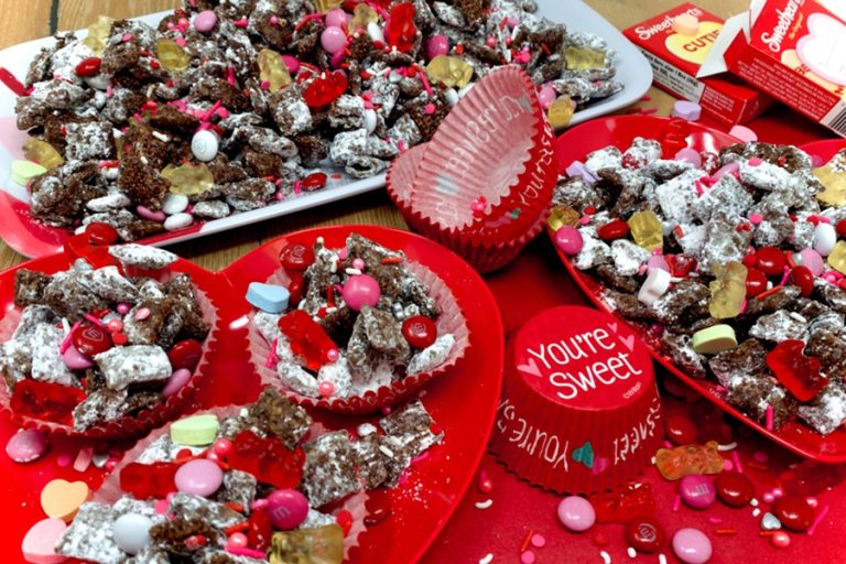 Valentines Puppy Chow Recipe Separated into Small Cupcake Cups That Say "You're Sweet"