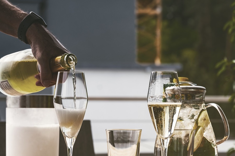 Best Champagne Cocktails for New Year's Eve a Person Pouring Champagne into Glasses