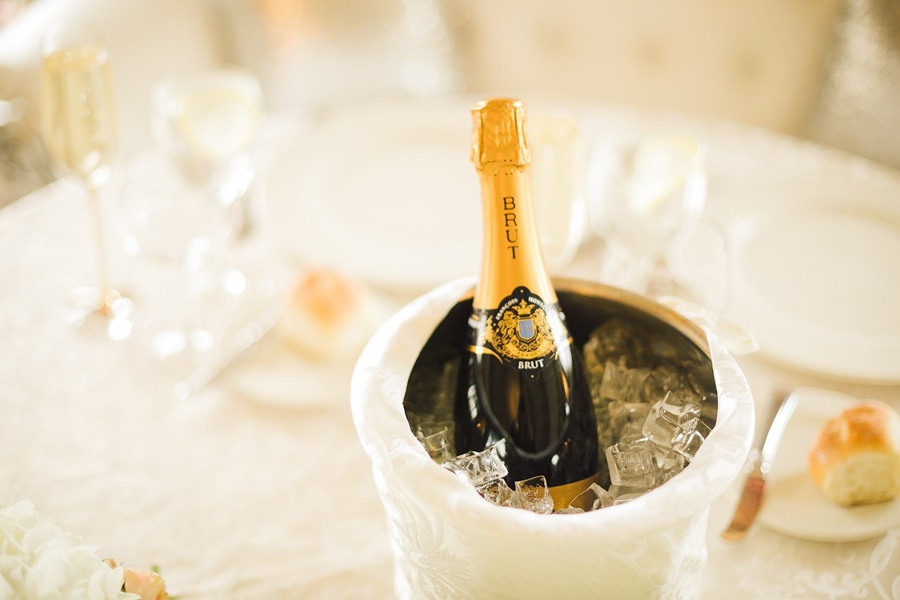 Best Champagne Cocktails for New Year's Eve a Bottle of Champagne in an Ice Bucket Filled with Ice on a White Table