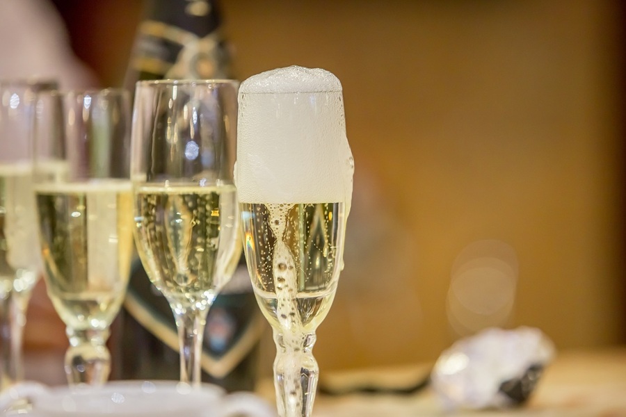 View of Glasses of Champagne on a Table Champagne Glasses Overflowing with Champagne